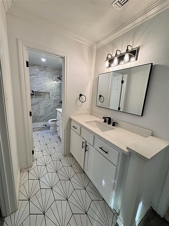 9112 Shiloh Road Dallas, TX 75228 - Photo 10 of 17 a spacious bathroom with a sink a toilet and mirror