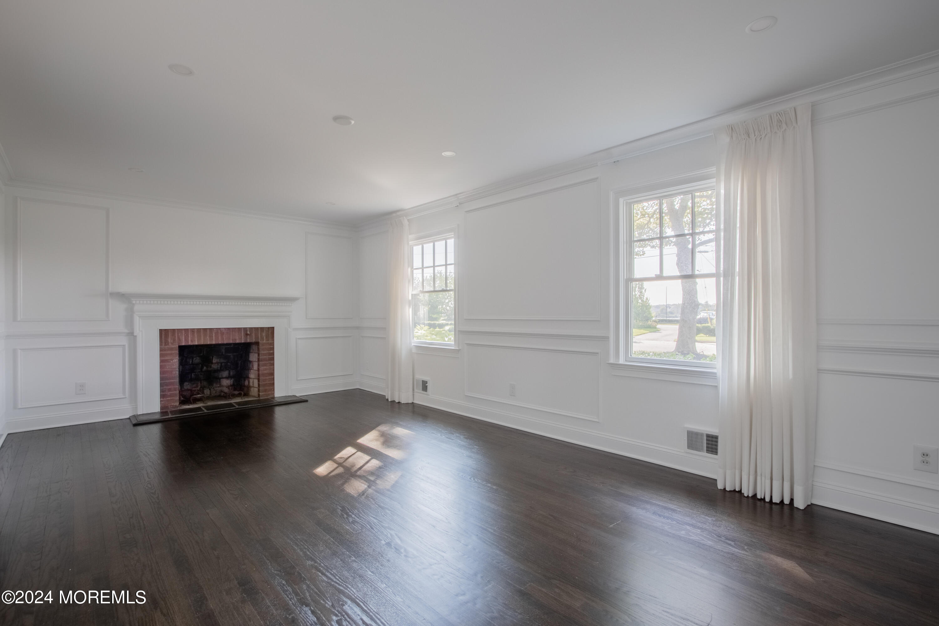 67 Rivers Edge Drive Little Silver, NJ 07739 - Photo 11 of 40 an empty room with wooden floor fireplace and windows