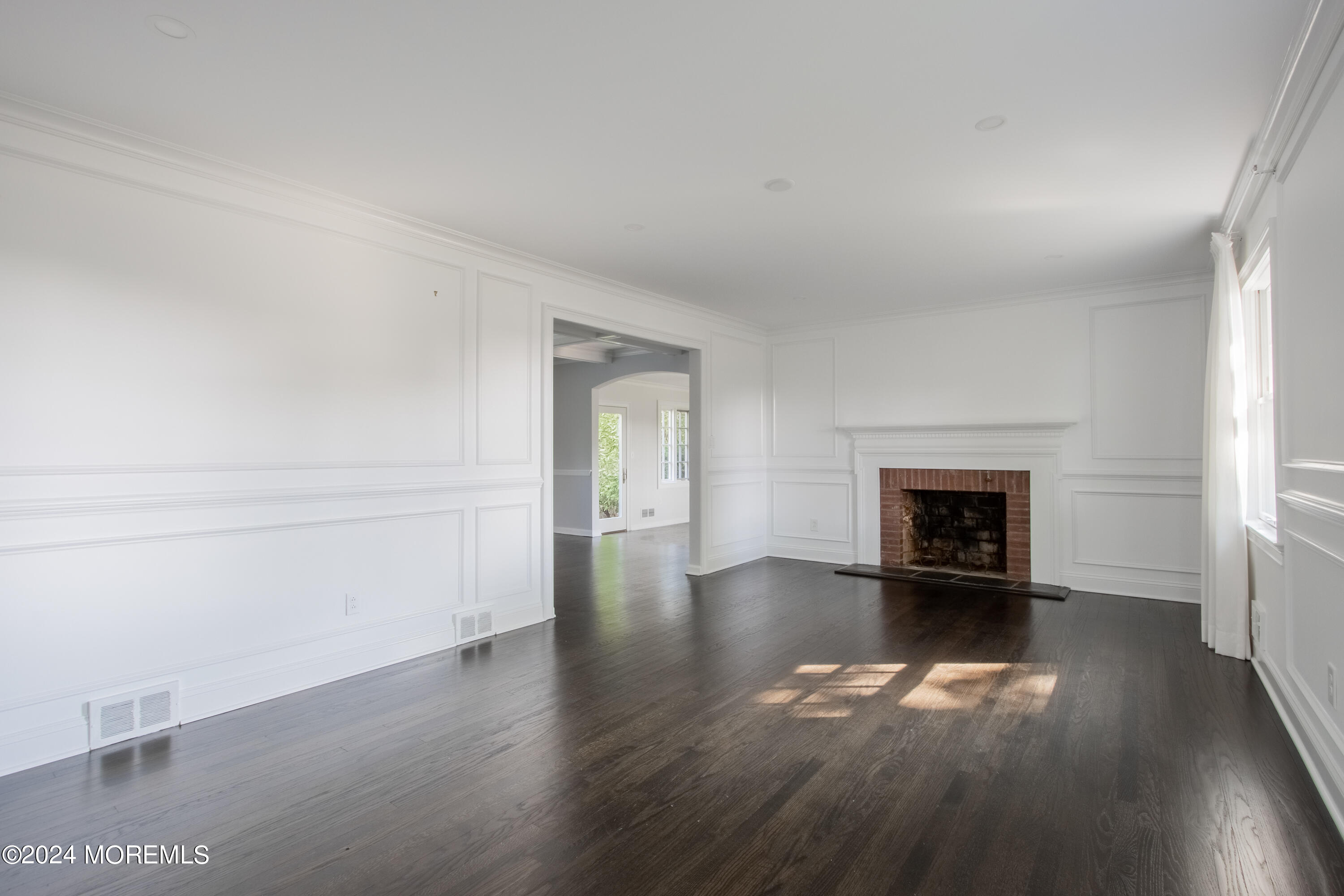 67 Rivers Edge Drive Little Silver, NJ 07739 - Photo 12 of 40 an empty room with wooden floor fireplace and windows