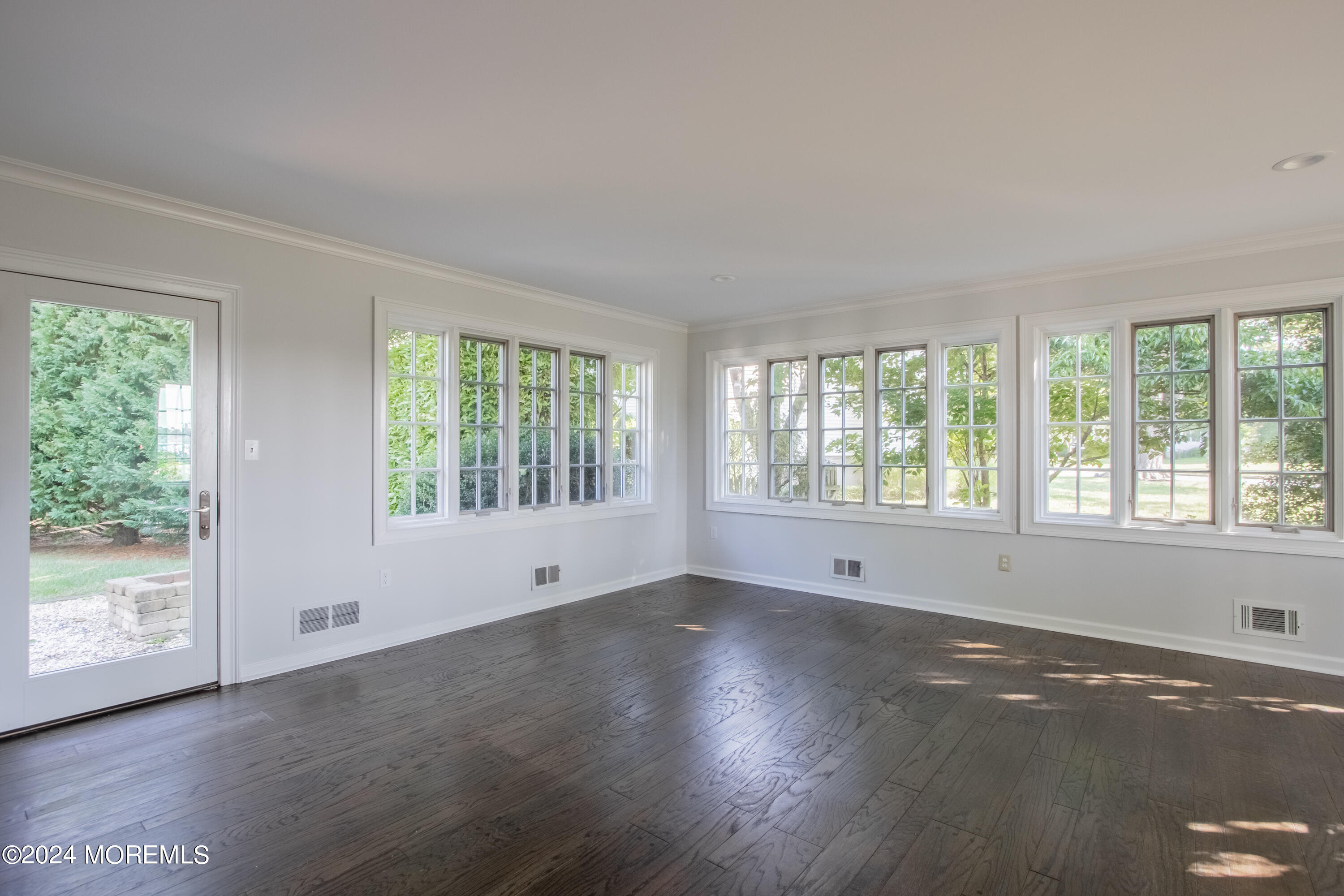 67 Rivers Edge Drive Little Silver, NJ 07739 - Photo 16 of 40 a view of an empty room with wooden floor and a window