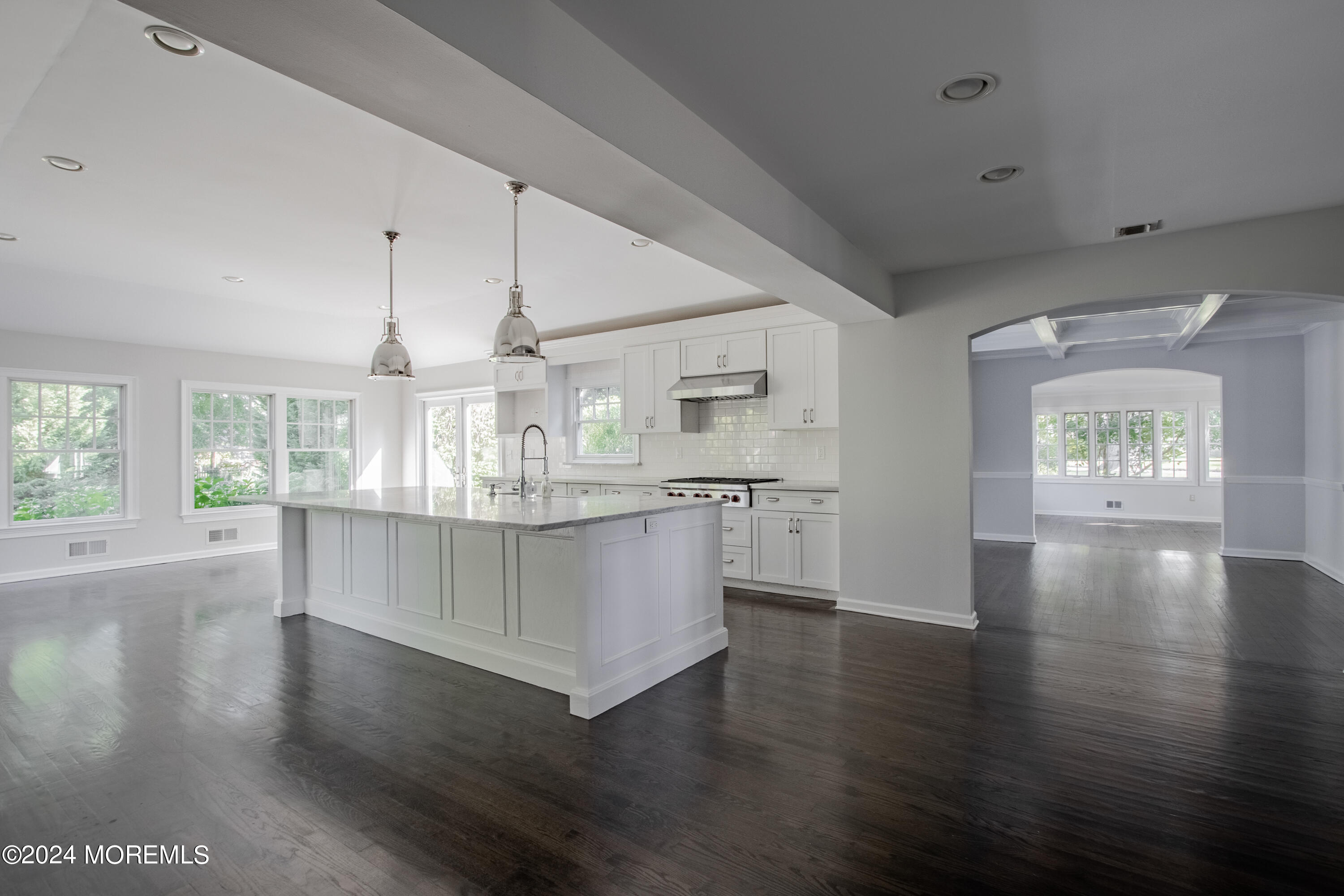 67 Rivers Edge Drive Little Silver, NJ 07739 - Photo 7 of 40 a kitchen with stainless steel appliances granite countertop wooden floors and white walls
