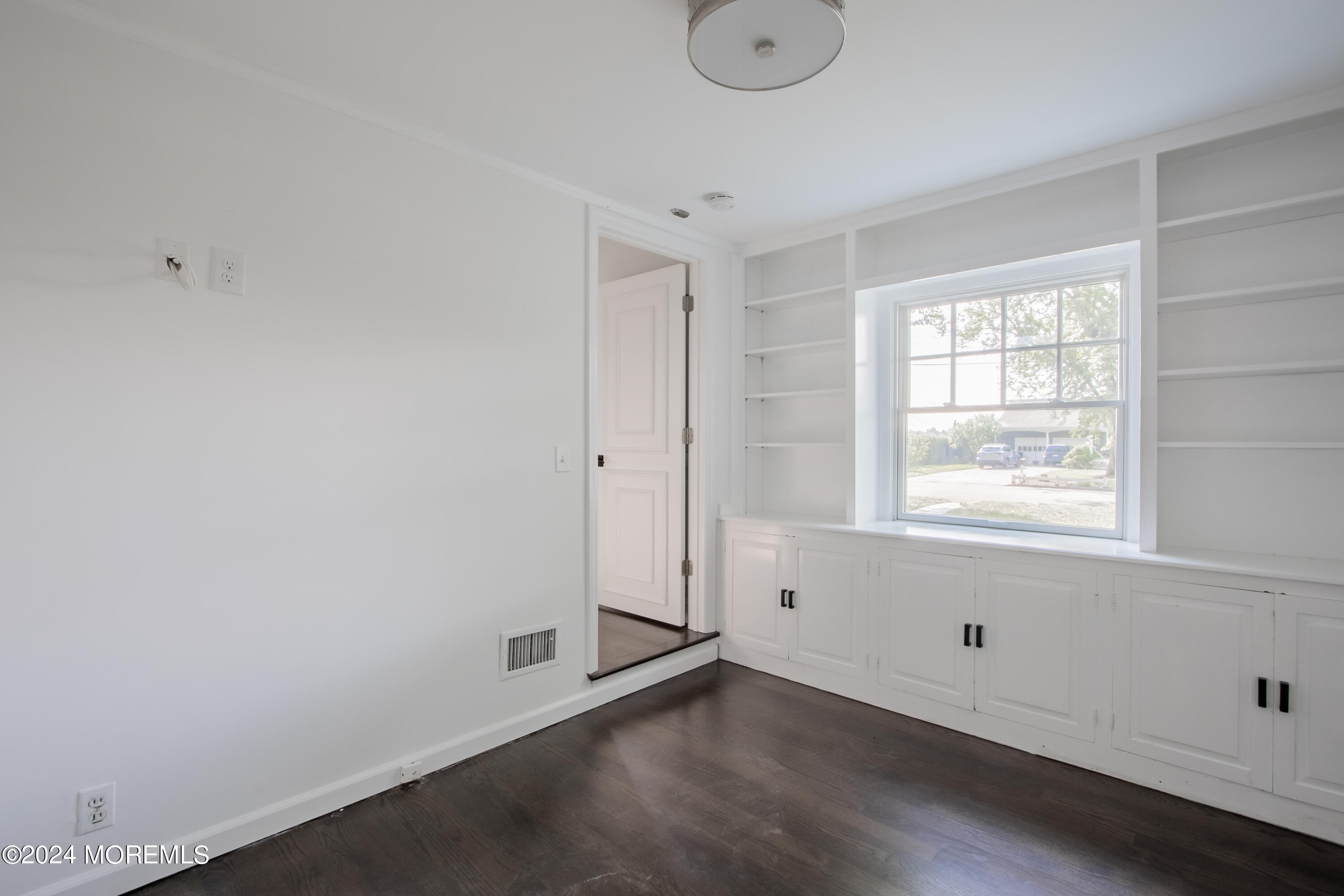 67 Rivers Edge Drive Little Silver, NJ 07739 - Photo 10 of 40 a view of an empty room with wooden floor and a window