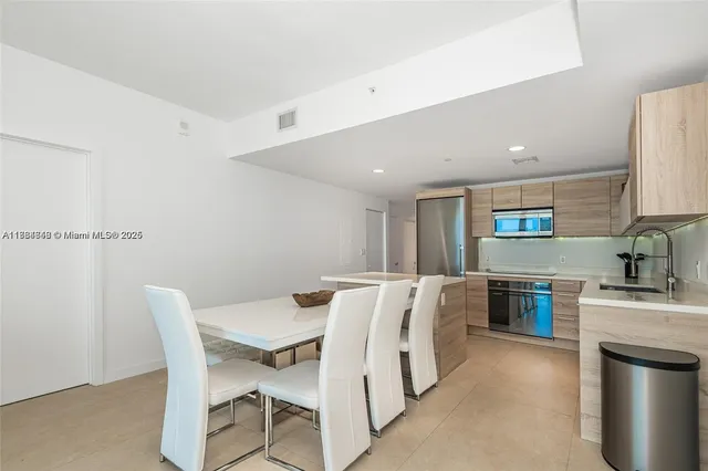 a living room with stainless steel appliances granite countertop furniture and a kitchen counter top