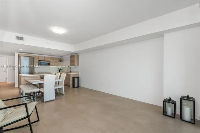 a view of a livingroom with furniture and a window