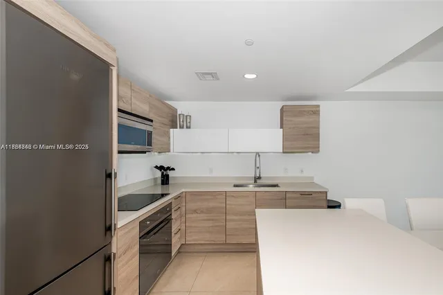 a kitchen that has a sink and a stove in it