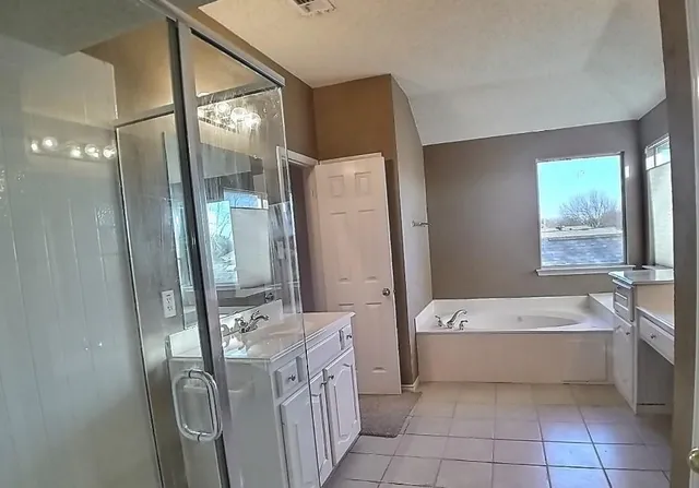 a bathroom with a bathtub sink and mirror