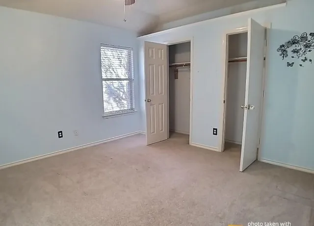 an empty room with windows and closet