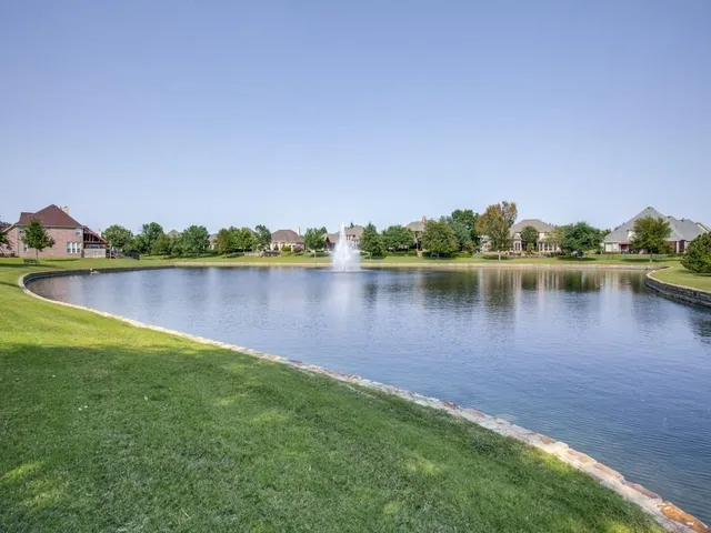 a view of a lake with houses in the back