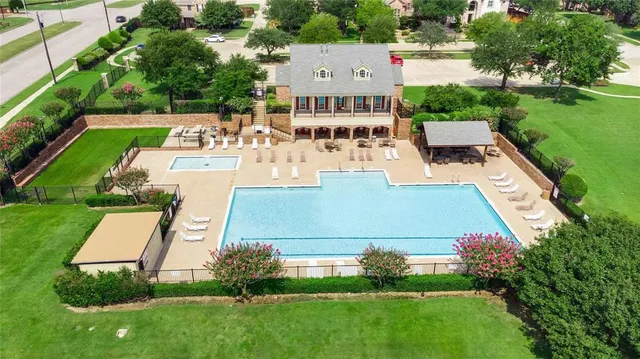 an aerial view of a house with garden space and street view
