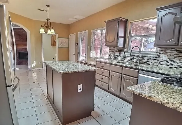 a bathroom with a granite countertop sink a mirror and vanity