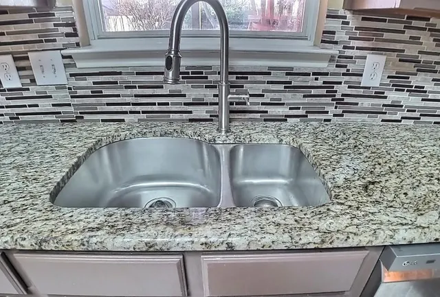 a close view of kitchen sink and microwave