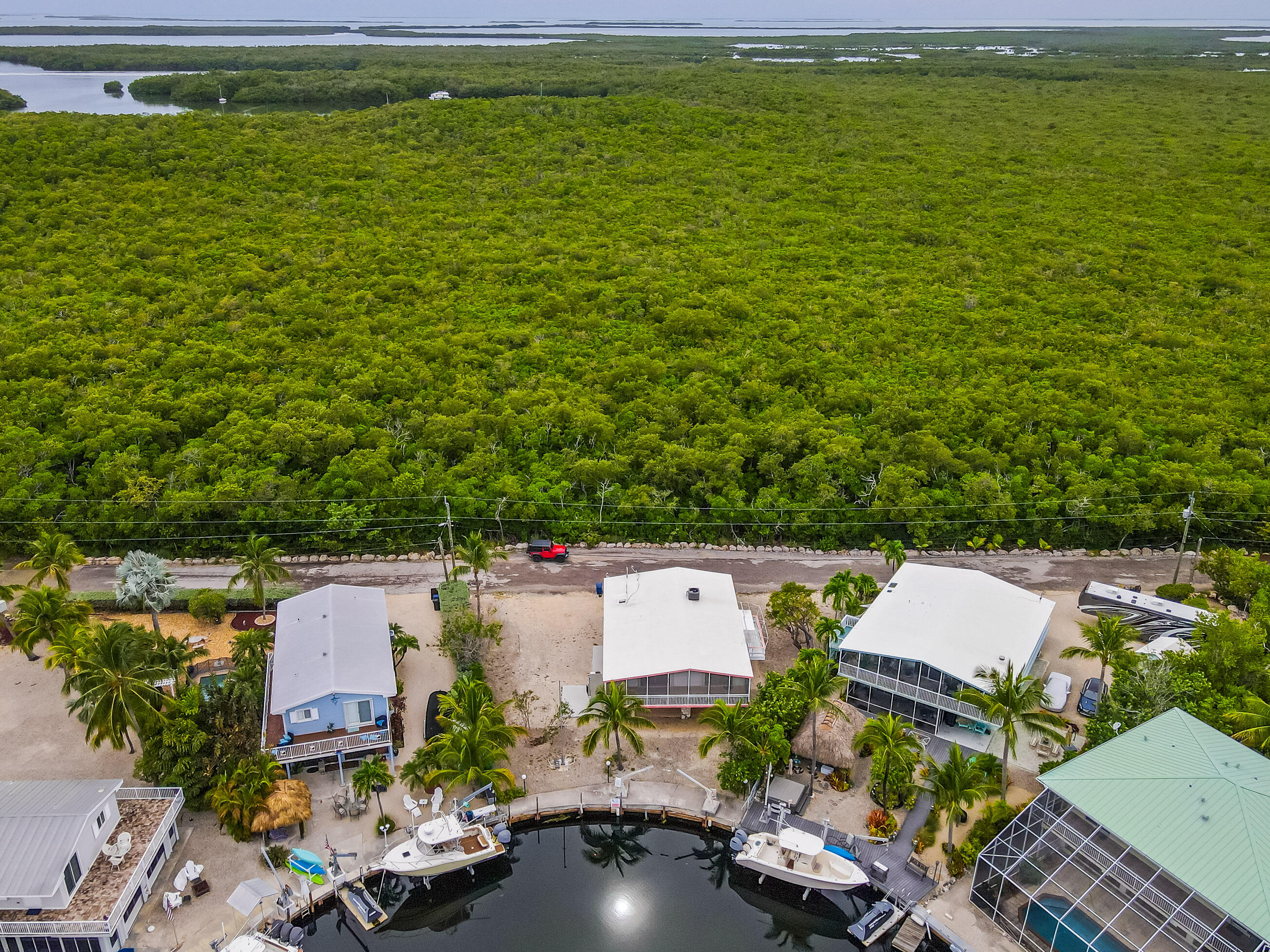 1502 Shaw Drive Key Largo, FL 33037 - Photo 12 of 42 an aerial view of a house with garden space and lake view in back