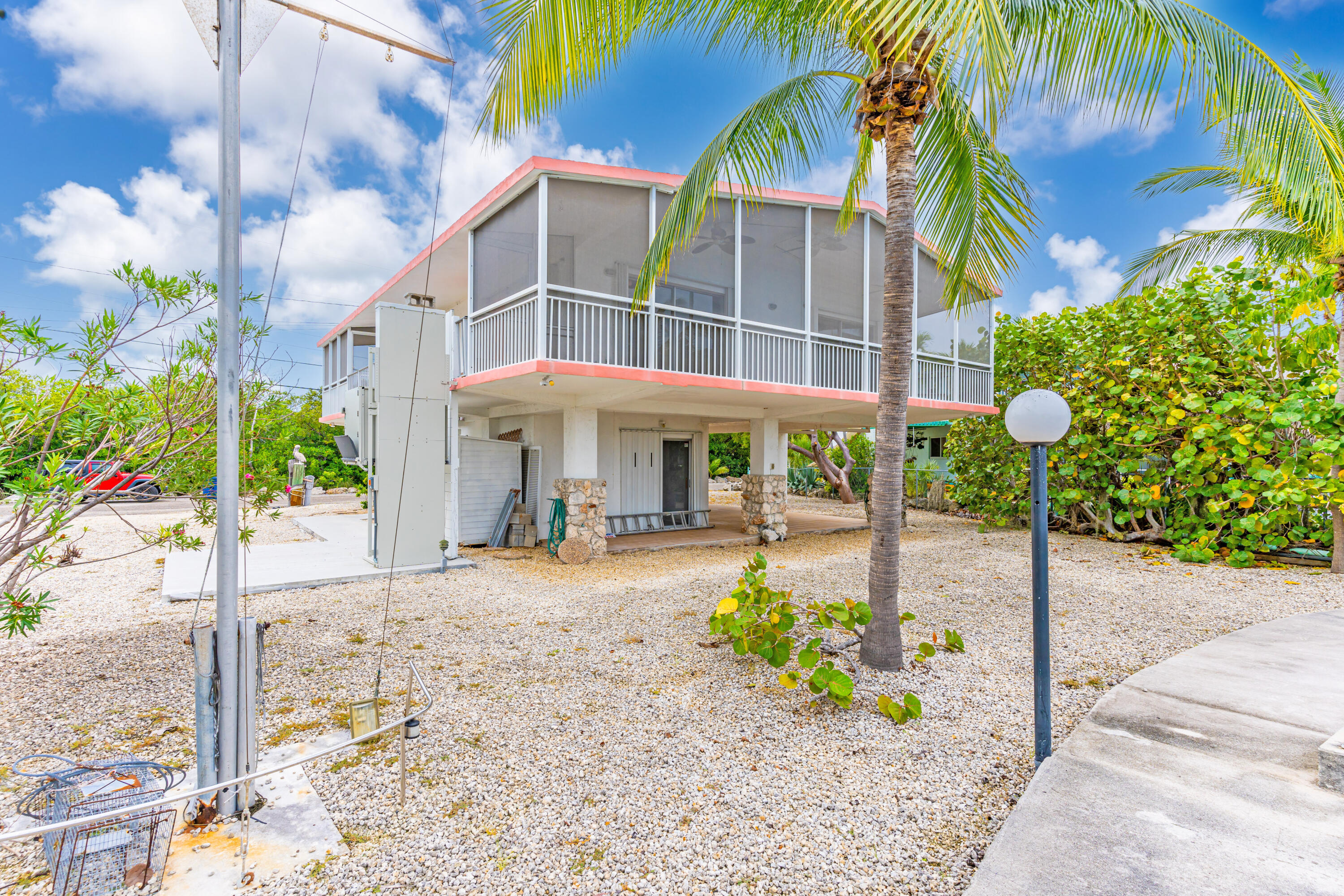 1502 Shaw Drive Key Largo, FL 33037 - Photo 34 of 42 a front view of a building with a garden