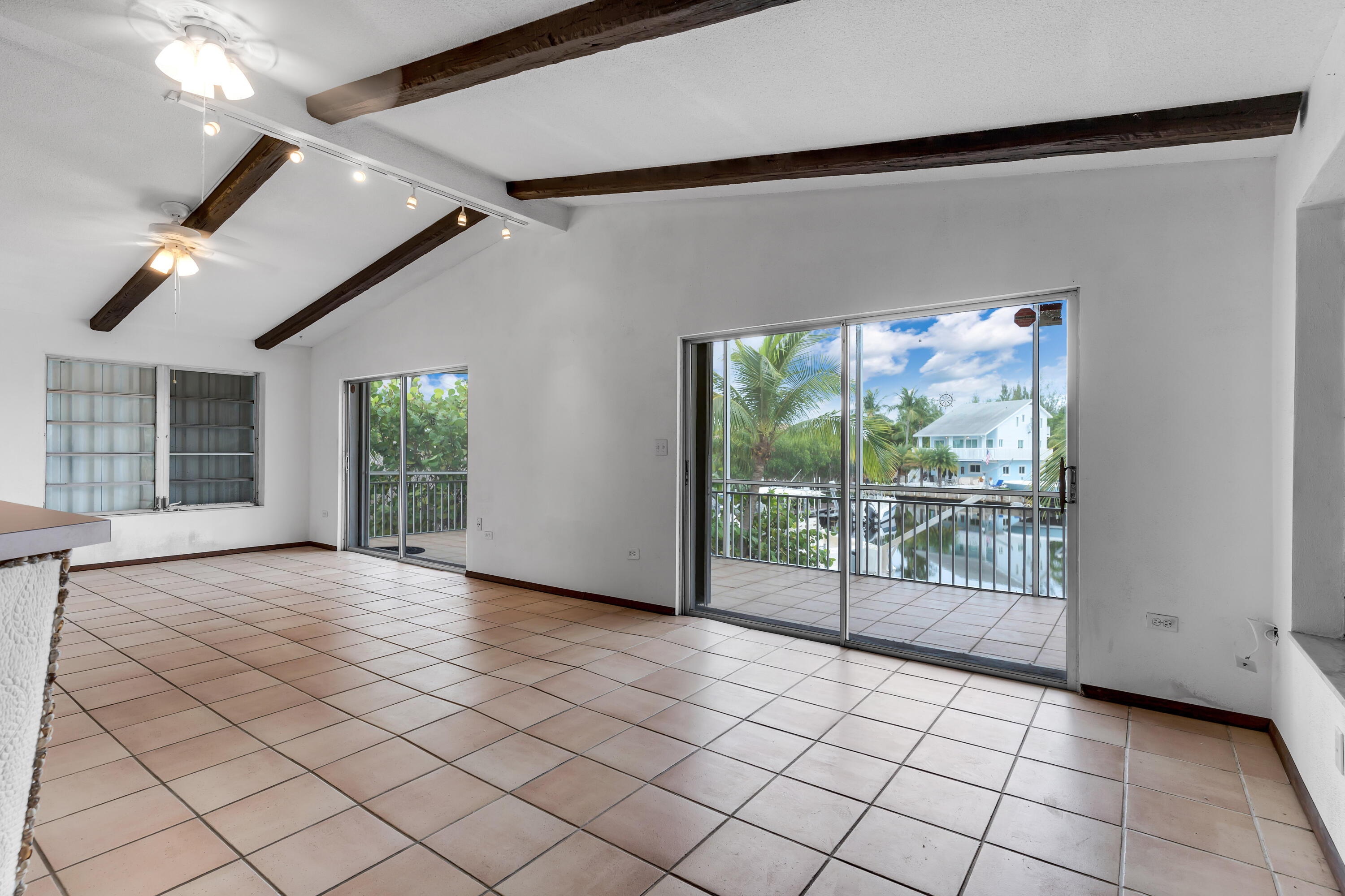 1502 Shaw Drive Key Largo, FL 33037 - Photo 5 of 42 a view of empty room with wooden floor and fan