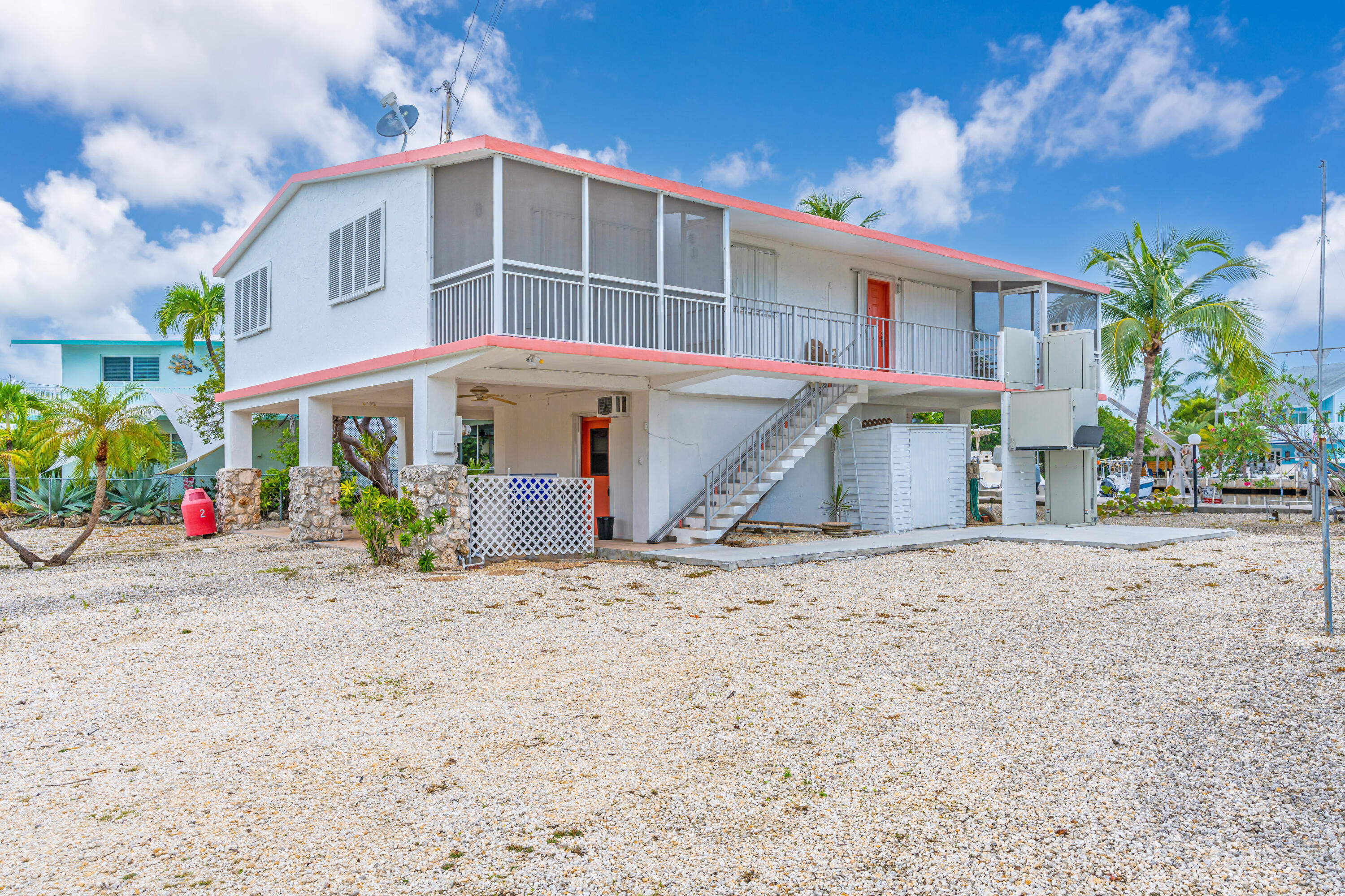 1502 Shaw Drive Key Largo, FL 33037 - Photo 8 of 42 a front view of a house with a yard and garage