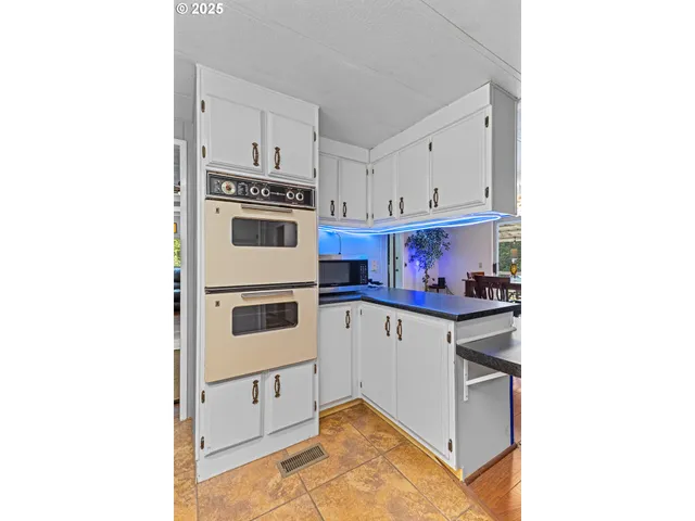 a kitchen with stainless steel appliances granite countertop a stove and a microwave