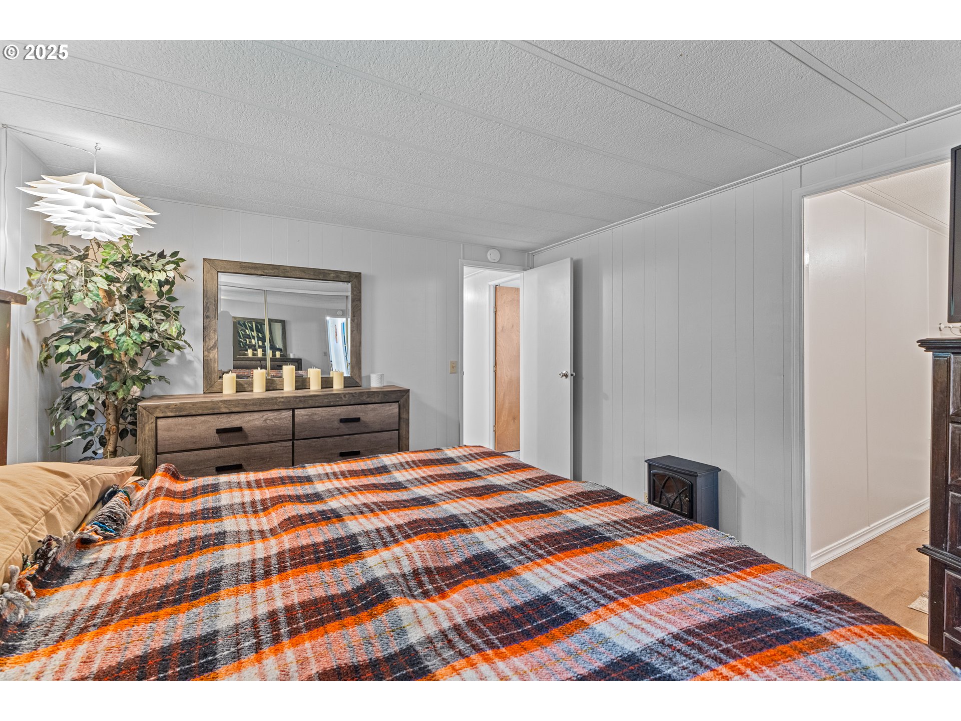98785 Sitkum Lane Myrtle Point, OR 97458 - Photo 19 of 45 a bedroom with a bed and wooden floor