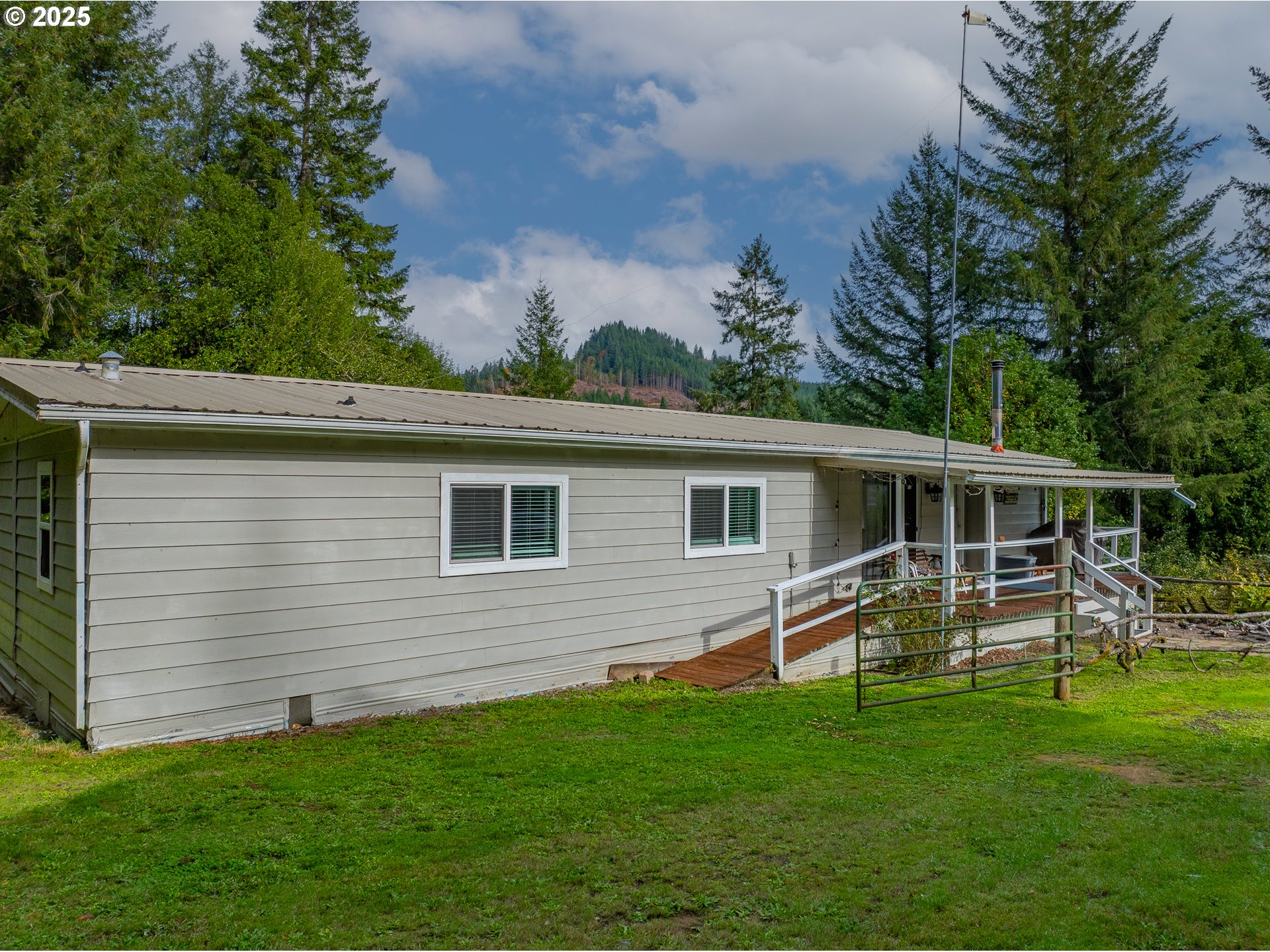 98785 Sitkum Lane Myrtle Point, OR 97458 - Photo 2 of 45 a backyard of a house with wooden floor and fence