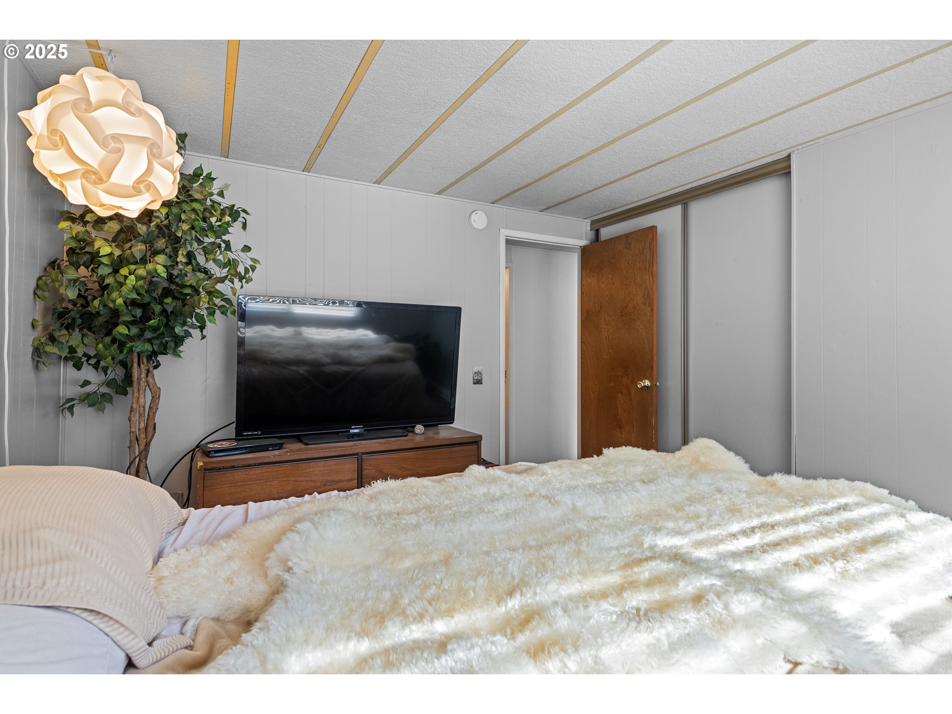 98785 Sitkum Lane Myrtle Point, OR 97458 - Photo 23 of 45 a bedroom with a bed and a flat screen tv