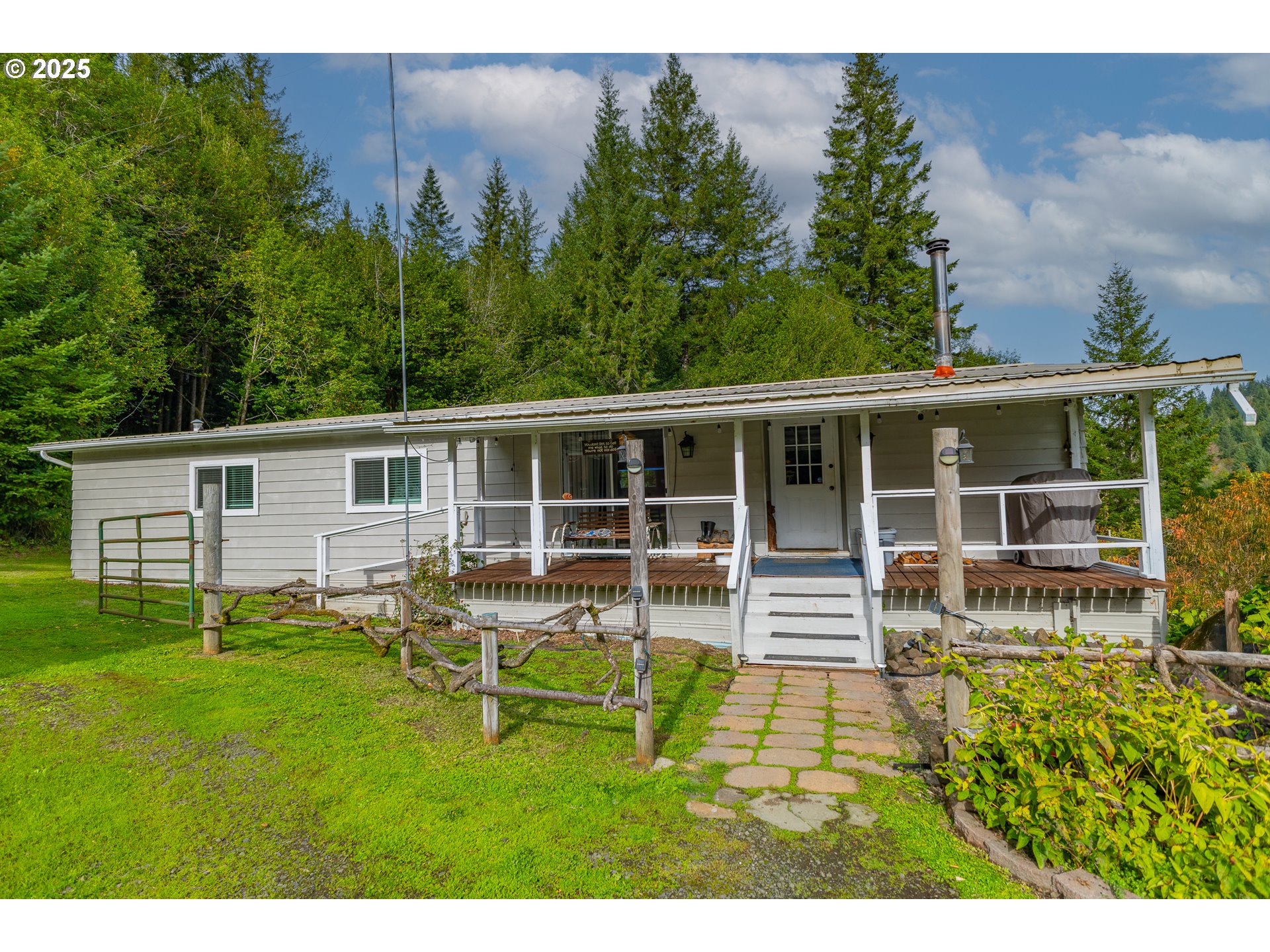 98785 Sitkum Lane Myrtle Point, OR 97458 - Photo 3 of 45 a view of a house with backyard sitting area and garden