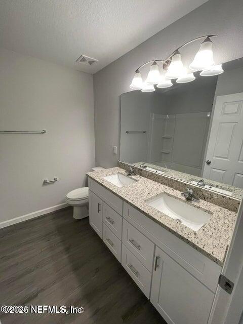 7426 Bowden Road Jacksonville, FL 32216 - Photo 14 of 23 a bathroom with a granite countertop sink and a mirror