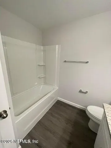 a bathroom with a bathtub and toilet