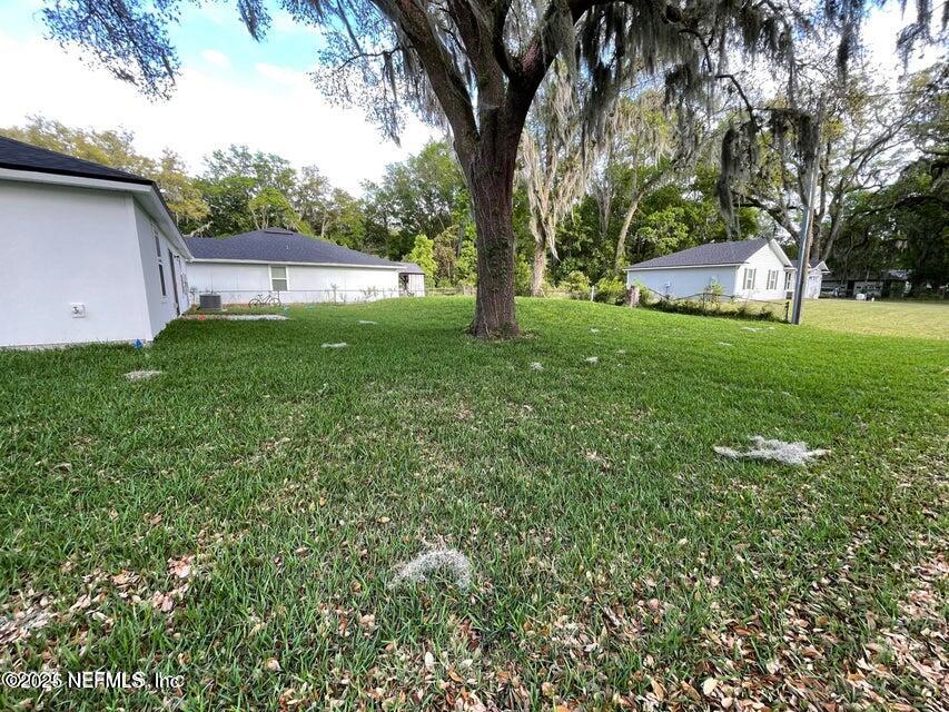 7426 Bowden Road Jacksonville, FL 32216 - Photo 20 of 23 a front view of a house with garden