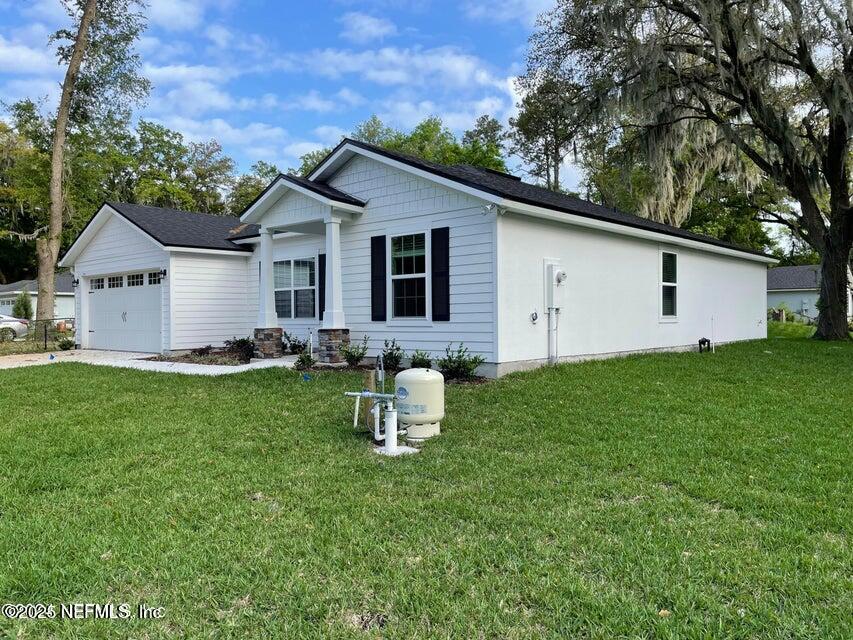 7426 Bowden Road Jacksonville, FL 32216 - Photo 2 of 23 a view of a house with backyard and garden