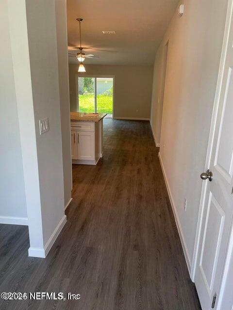 7426 Bowden Road Jacksonville, FL 32216 - Photo 3 of 23 wooden floor in an empty room with a window
