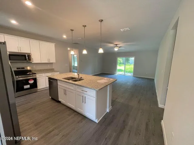 a kitchen with a stove sink and a refrigerator