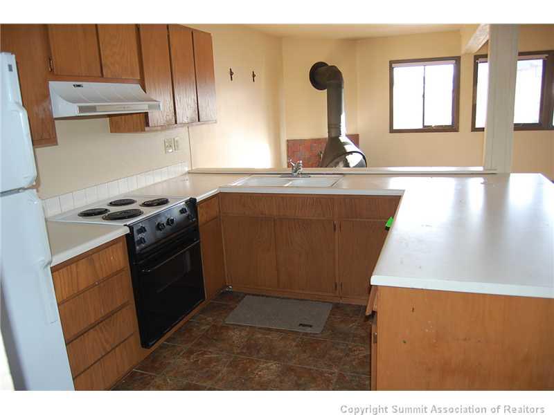 102 Salt Lick Circle, Unit 5 Silverthorne, CO 80498 - Photo 8 of 21 a kitchen with granite countertop a stove and a sink