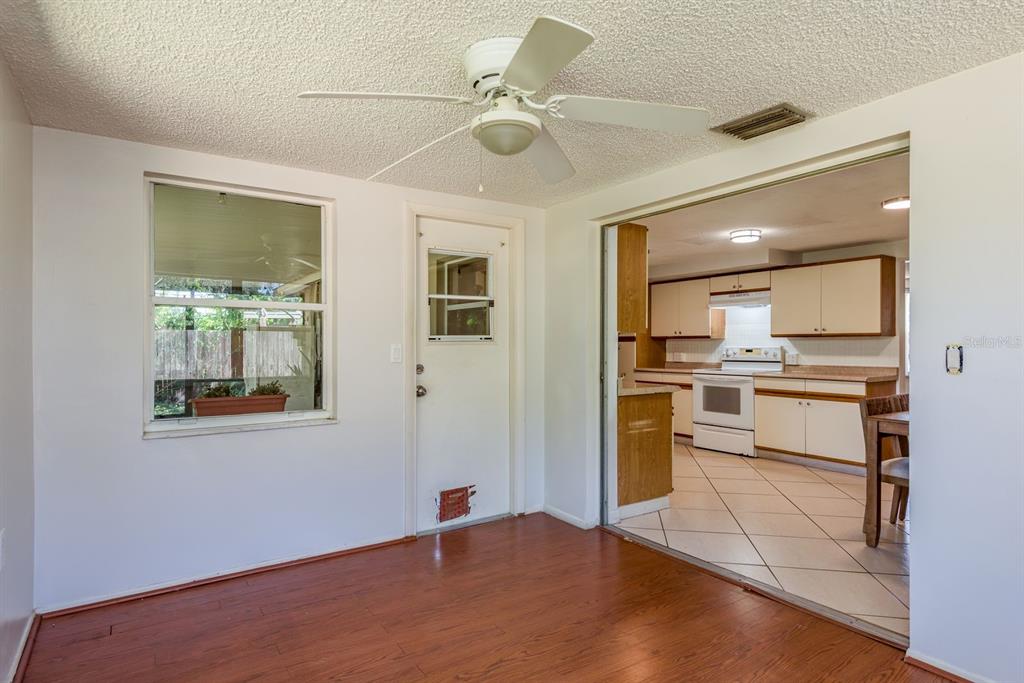 1748 Colmar Drive Holiday, FL 34690 - Photo 15 of 29 a kitchen with a refrigerator and white cabinets