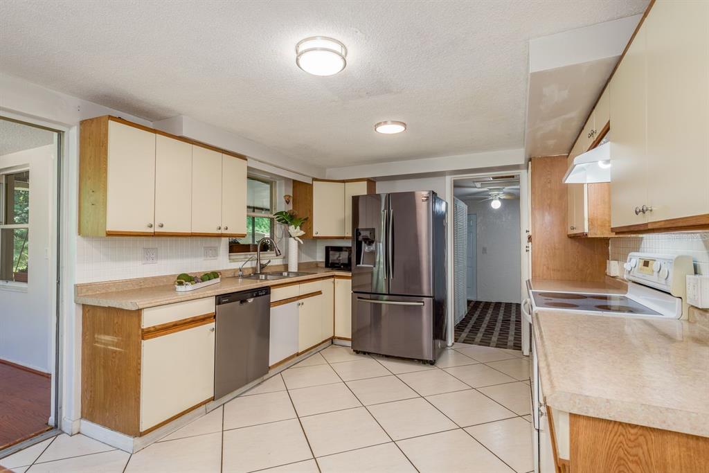 1748 Colmar Drive Holiday, FL 34690 - Photo 2 of 29 a kitchen with stainless steel appliances granite countertop a refrigerator sink and stove