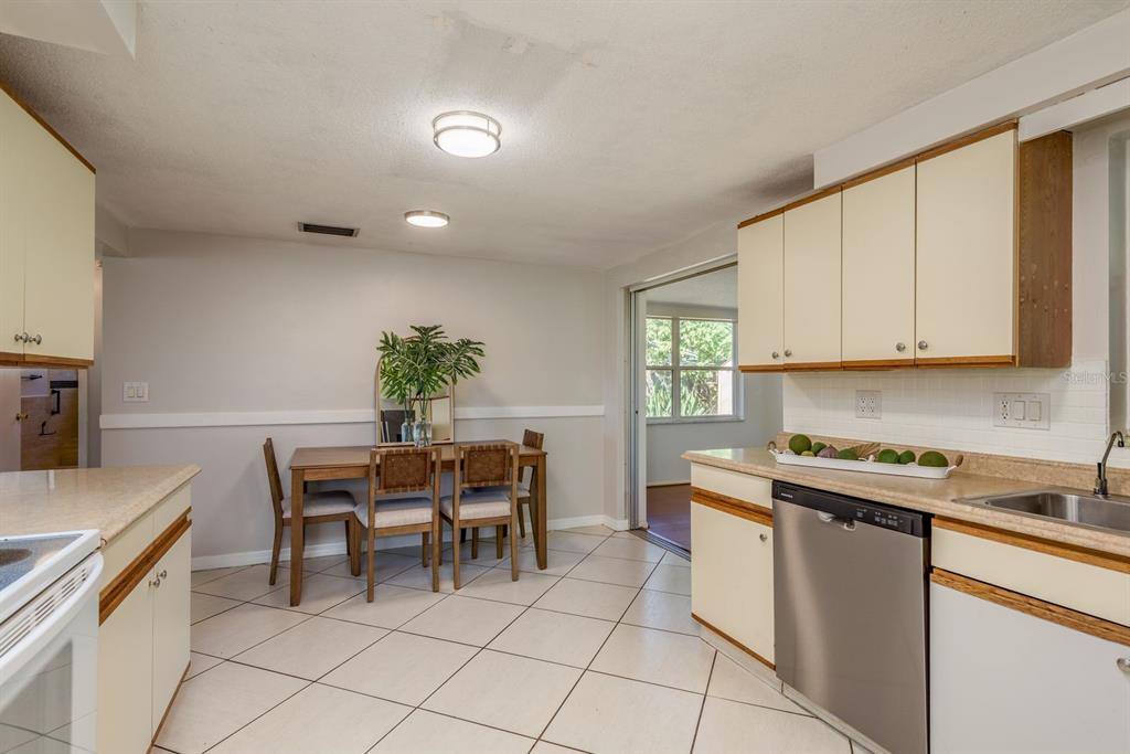1748 Colmar Drive Holiday, FL 34690 - Photo 5 of 29 a kitchen with a sink and chairs