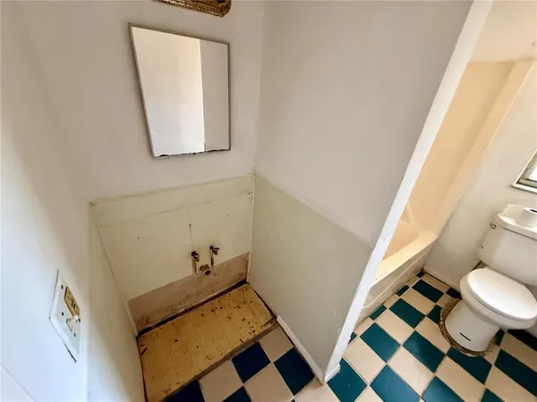 a bathroom with a sink and mirror with toilet