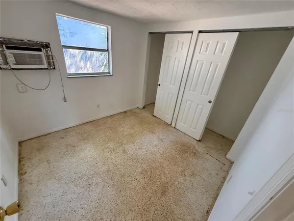 a view of a house with an empty space and wooden floor