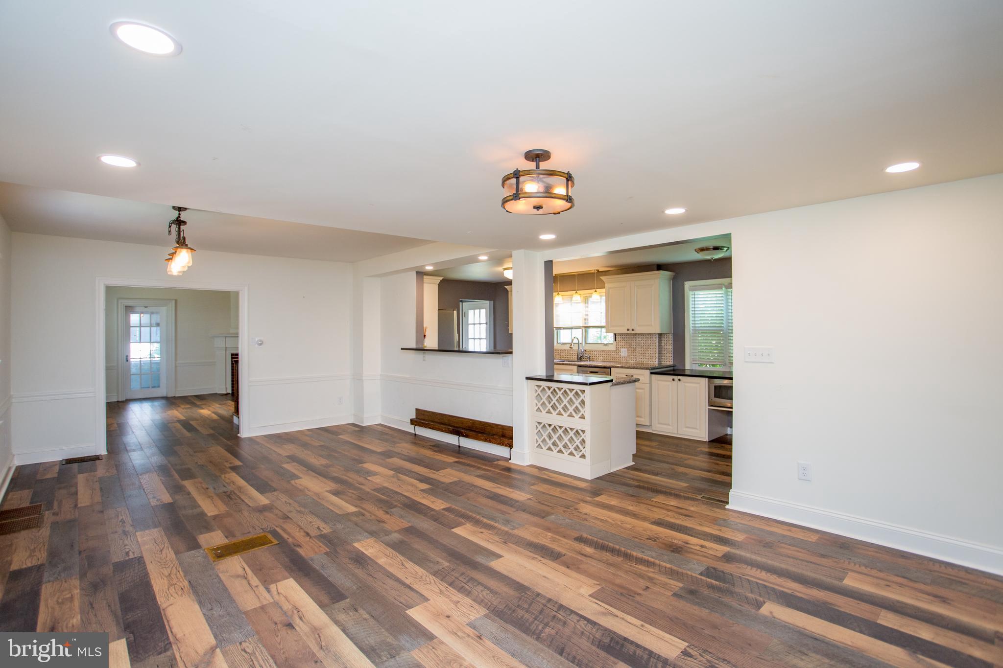 105 Wilson Avenue Hellertown, PA 18055 - Photo 12 of 46 a view of a room with kitchen island stainless steel appliances wooden floor and window