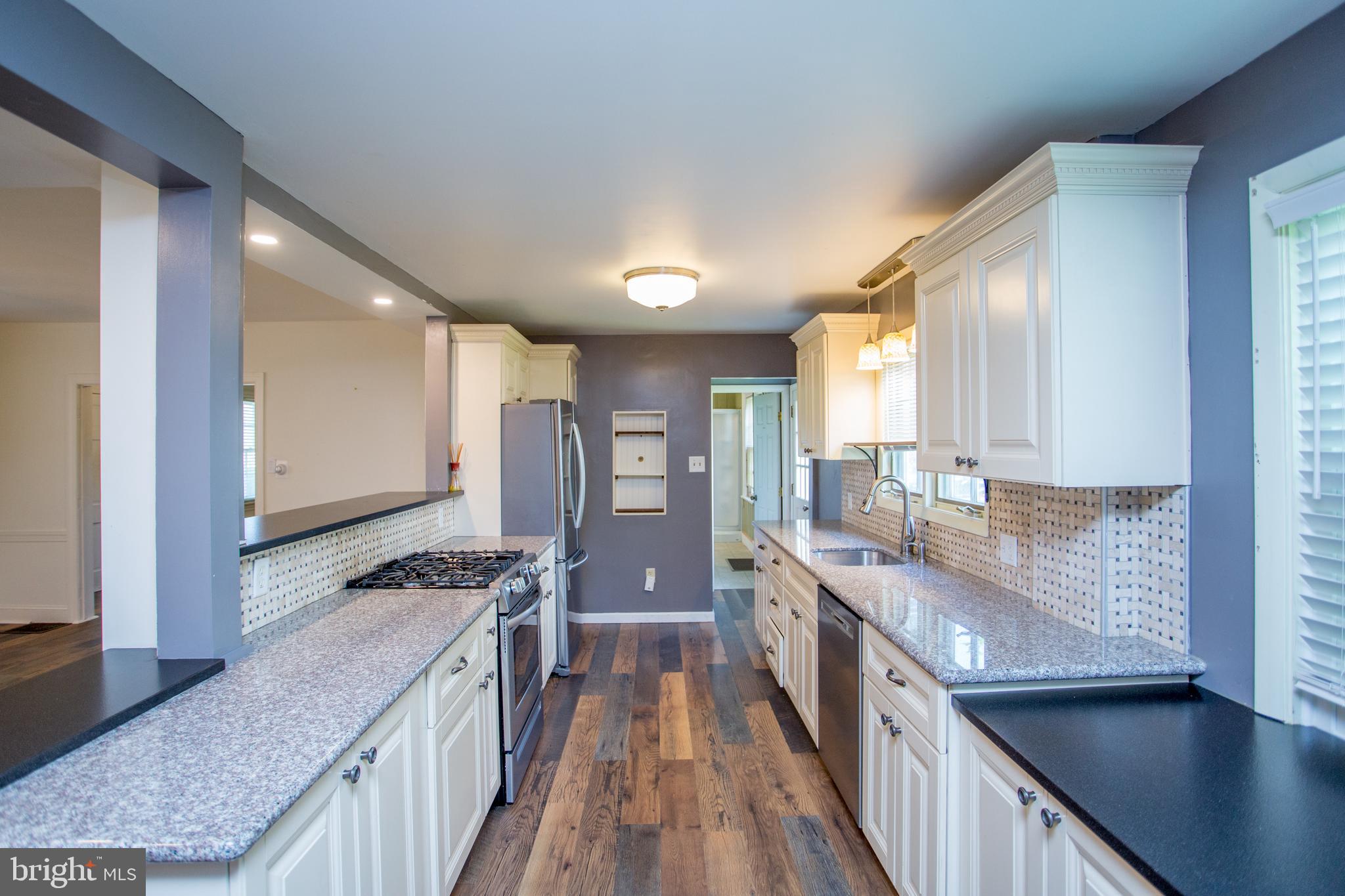 105 Wilson Avenue Hellertown, PA 18055 - Photo 14 of 46 a kitchen with stainless steel appliances granite countertop a stove and a sink