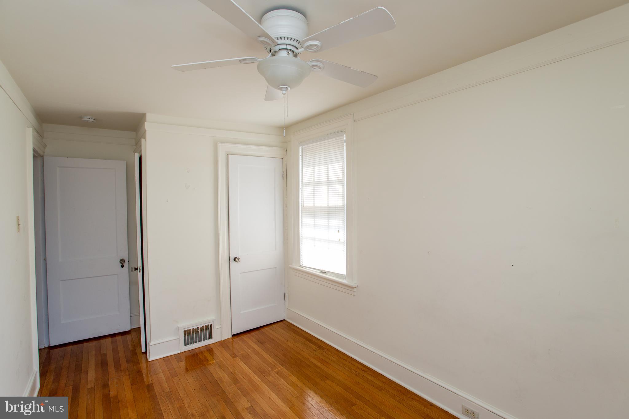 105 Wilson Avenue Hellertown, PA 18055 - Photo 24 of 46 an empty room with wooden floor ceiling fan and windows