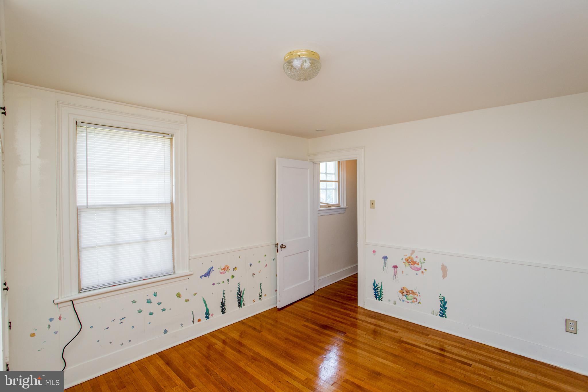 105 Wilson Avenue Hellertown, PA 18055 - Photo 27 of 46 a view of an empty room with window and wooden floor