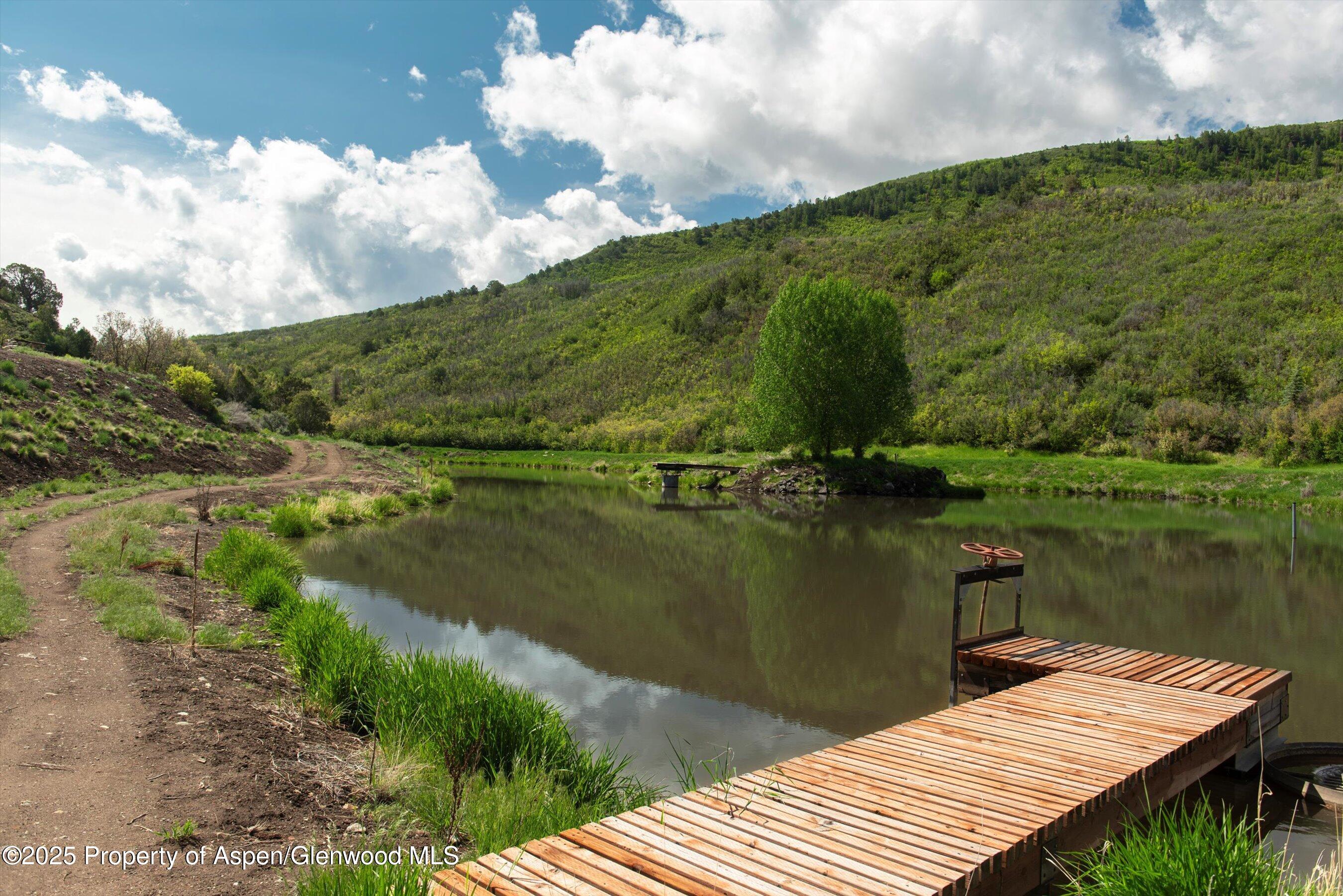 3691 East Sopris Creek Road Basalt, CO 81621 - Photo 7 of 21 a view of a lake with a mountain in the background