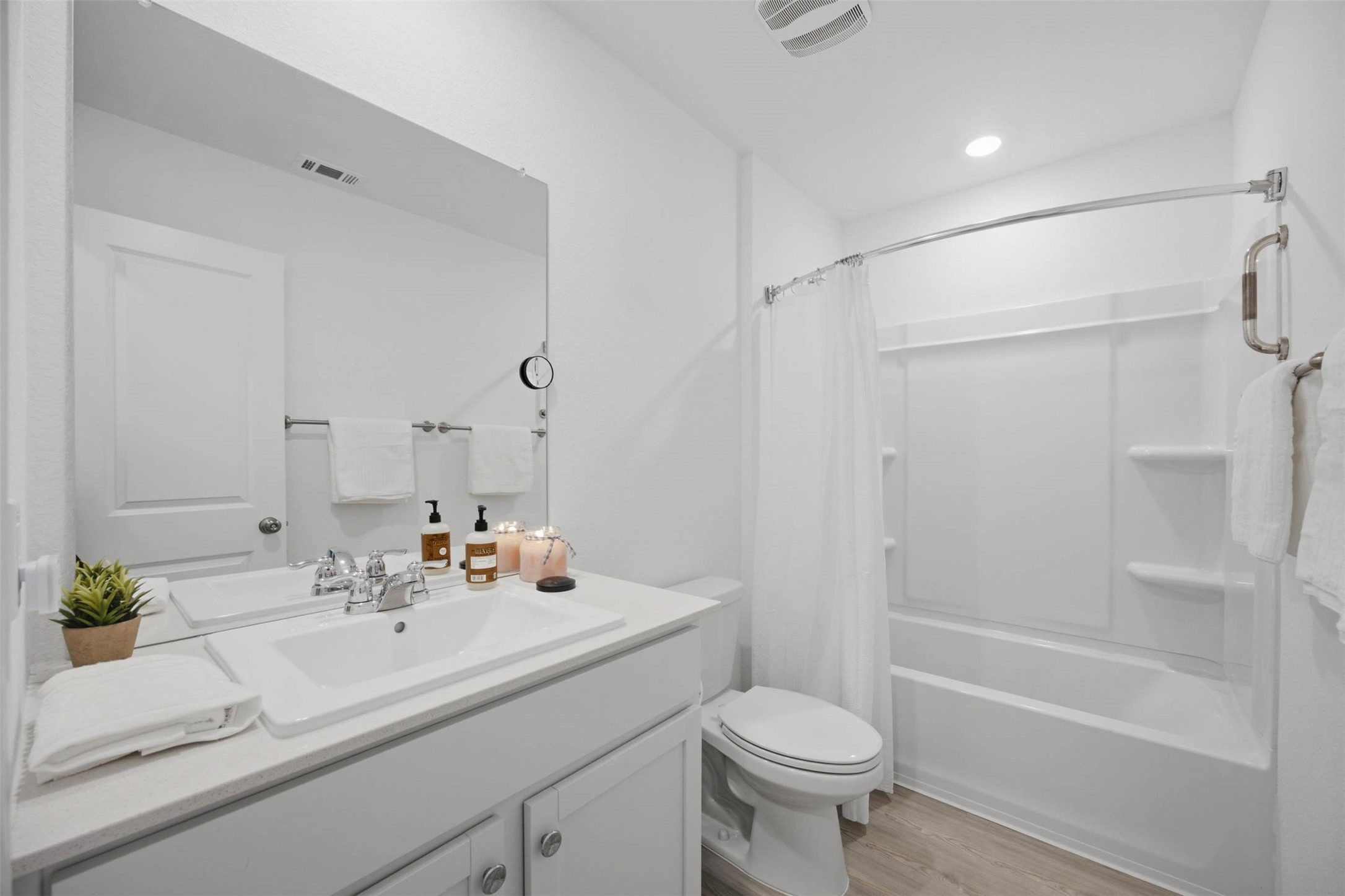 171 Cattle Queen Road Jarrell, TX 76537 - Photo 19 of 38 Crisp white finishes and a tub-shower combination define this functional bathroom space.