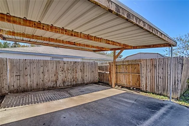 a view of a patio with wooden fence