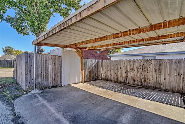 a view of a backyard with wooden fence