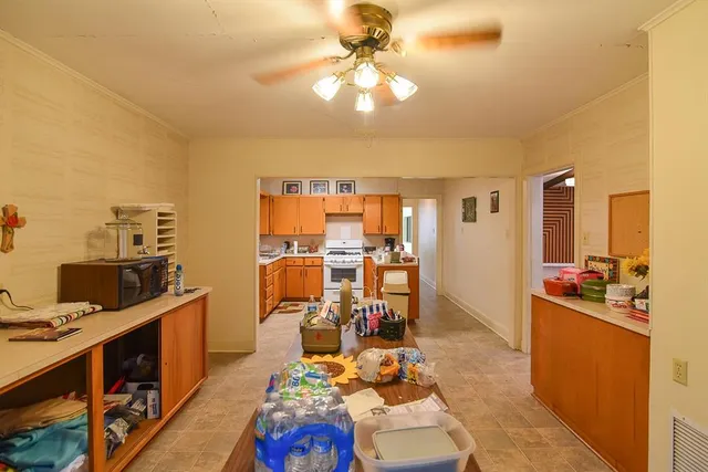 a view of a workspace with furniture and a kitchen