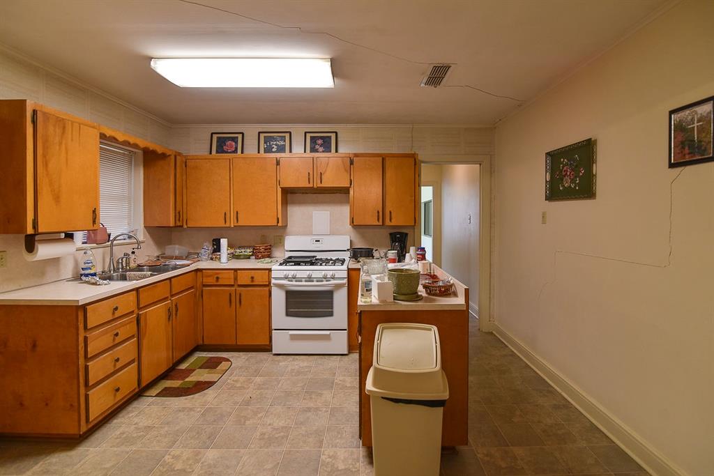 4403 Phillips Drive Wichita Falls, TX 76308 - Photo 13 of 40 a kitchen with a stove top oven sink and cabinets