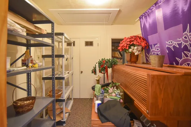 a living room with furniture and flowers