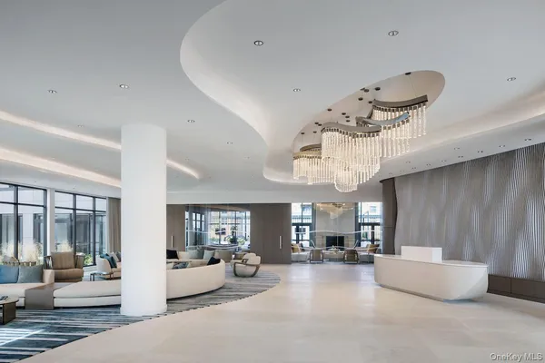 a living room with furniture and chandelier