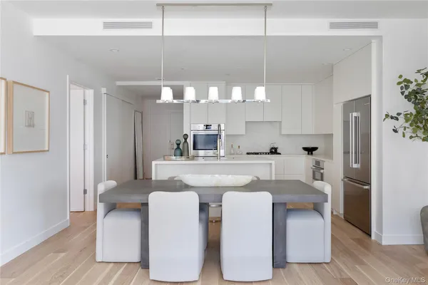 a kitchen with cabinets and chairs