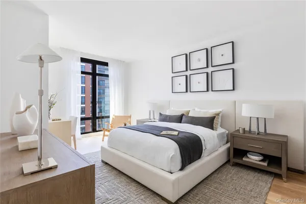 a bedroom with a bed a mirror and a window